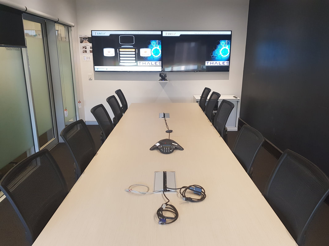 Thales corporate boardroom with dual displays and conferencing